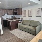 Living area, wood stove, loft access